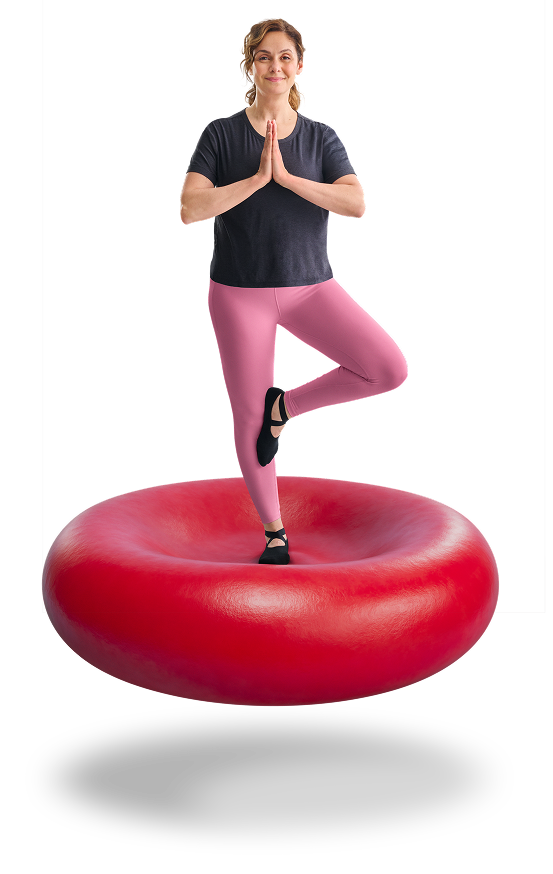 Woman perfoming yoga on a red blood cell